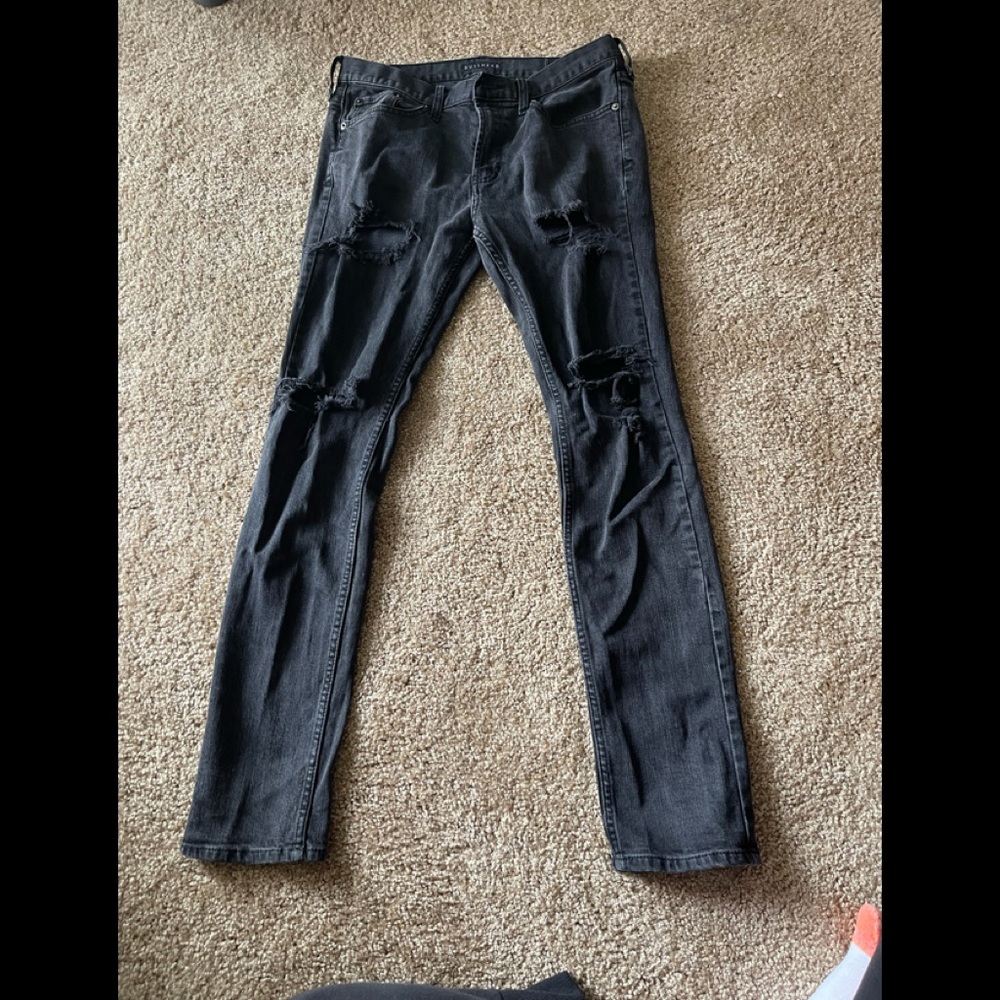 Black jeans with manufacturers holes